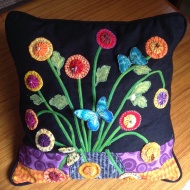 Joan's remarkable 3D cushion using yoyo's and bias stems